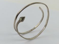 A white metal upper arm bangle in the form of a coiled snake having Abalone shell head.
