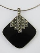 An Art Deco style silver and marcasite pendant measuring 4cm in length, stamped 925,