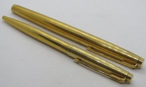 A Parker '75' Ciselle fountain pen and ballpoint pen set, fountain pen having 14ct gold nib,