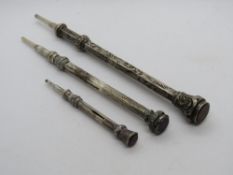 Three propelling pencils the smaller two hallmarked for Birmingham, larger, no apparent hallmark,