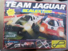 A Scalextric Team Jaguar race track in used condition having one car within.