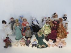 A quantity of soft body ceramic faced dolls house figures.