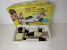 A Radio Shack radio controlled Formula-1 racing car in original packaging. Untested.