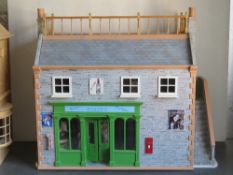 A dolls house having been designed as a greengrocer's with generous array of products on display,
