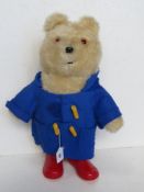 A Paddington soft toy figurine complete with duffel coat and boots, approx 48cm high.