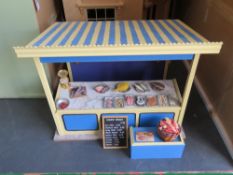 A dolls house fishmongers market stall with sign and wares.