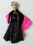 A Special Edition Barbie doll in black and silver dress.