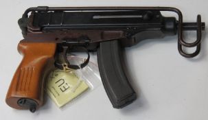 A deactivated Czech Skorpion Wz61 7.65mm sub machine gun with slotted wooden grip.