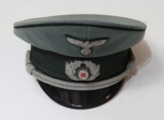 A WWII German Officers Pioneer Visor Cap with the celluloid lozenge still in place.