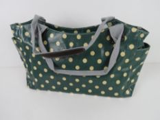 A green polka dot pattern handbag 'as ne