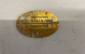 A WWII German Kriegsmarine dog tag.