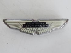 An enamelled metal Aston Martin car badge.