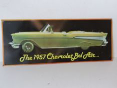 A contemporary metal sign 'The 1957 Chevrolet Bel Air' approx 56cm wide.