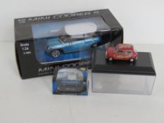 A die cast Mini Cooper 1:72 scale by Cararama together with a radio controlled Mini Cooper S and a