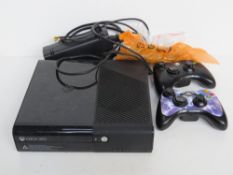 An Xbox 360 with cables and controllers.