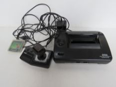 A Sega Master System II power base with game cartridge and controller.