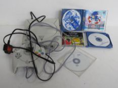 A Dreamcast console with controller and games.