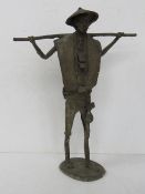 A Brutalist metal sculpture of an Oriental gentleman with cane over shoulders standing 37cm high.