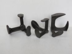 Three cast iron triple boot lasts.
