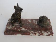 A French rouge marble standish having Alsatian and inkwell upon (inkwell hinge a/f), 25.5cm wide.