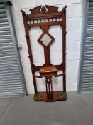 An Edwardian hall stand having central mirror and lidded compartment,
