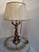 A large contemporary brass three-sconce table lamp complete with cream silk shade,