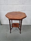 An octagonal occasional table with square undershelf raised over shaped legs.
