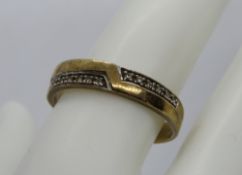 A 9ct gold ring having opposing bands of white metal set stones, hallmarked 375, size U, 3.5g.