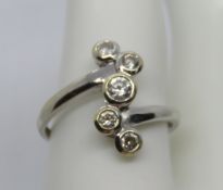 A 14ct white gold ring having bubble pattern set with five white stones, hallmarked 585, size U, 3.