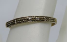 A yellow metal ring, no apparent hallmarks, repaired split to side, 0.8g.