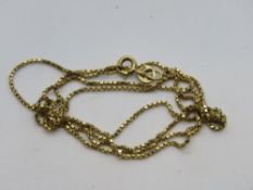 A yellow metal box link chain necklace, stamped 754, approx 62cm in length, 4.9g.