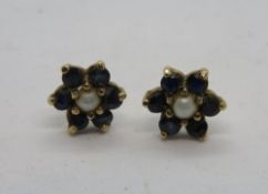 A pair of floral stud earrings, yellow metal, no apparent hallmarks.