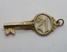 A 9ct gold '21' key charm or pendant, hallmarked 375, approx 3.5cm in length, 2.6g.