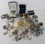 A quantity of assorted costume jewellery including faux pearl necklaces, rings, brooches, etc.