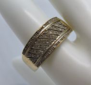 A 9ct gold ring having white stones set to the geometric patterned front, size W, hallmarked 375,