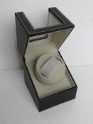A black leatherette automatic watch winder, no cable.