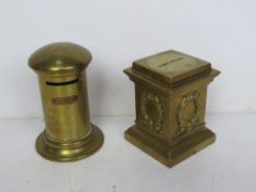 Two brass money boxes one in the form of a post box the other in the form of a Regency column.