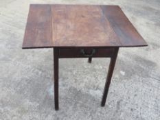 An oak drop leaf side table having single drawer under, 86 x 71cm extended, 71cm high.