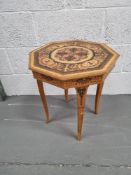 A musical side table, inlaid decoration opening to reveal compartments within.
