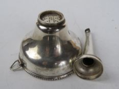A silver plated wine pourer.