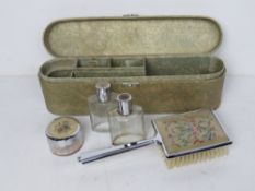 A delightful mid century dressing table set in travel case including glass perfume bottles,