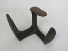 A cast iron triform boot last.