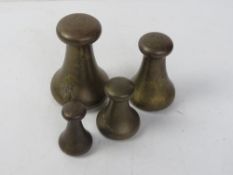 A set of four brass graduated weights by Avery; 7lb, 4lb, 2lb & 1lb.