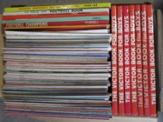 A quantity of The Victor Book for Boys, soccer themed books and DIY themed magazines.