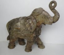 A delightful carved wooden sculpture of an elephant in ceremonial dress, a/f.