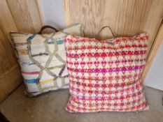 Two large floor cushions, woven patterned front, leatherette handles.