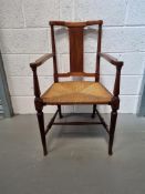 A single cane seated carver chair.