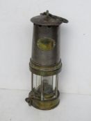 A reproduction miner's lamp marked “GPO Patterson Lamps Ltd Gateshead-on-Tyne.