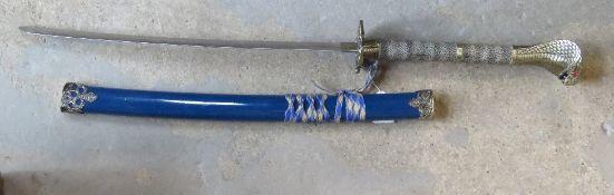 A contemporary decorative katana having cobra head handle.
