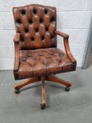 A Chesterfield type office chair on castors.
